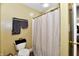 Bathroom features a shower with patterned curtain, toilet and matching towel racks at 8325 Chesterhill Ln, Indianapolis, IN 46239