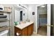 Cozy bathroom with light wood cabinets and a large mirror over the sink at 8325 Chesterhill Ln, Indianapolis, IN 46239