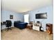 Spacious bedroom with neutral carpet, blue accent wall and modern furnishings at 8325 Chesterhill Ln, Indianapolis, IN 46239