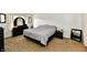 Neutral bedroom with black furnishings, including black dressers, black nightstands, and black framed mirror at 8325 Chesterhill Ln, Indianapolis, IN 46239