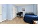 Bedroom features blue accent wall decorated with music notes, desk and closet at 8325 Chesterhill Ln, Indianapolis, IN 46239