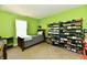 This bright green bedroom features a wall of shelves and a bed at 8325 Chesterhill Ln, Indianapolis, IN 46239