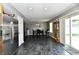 Spacious dining area adjacent to the kitchen features gray marbled floor and sliding glass door at 8325 Chesterhill Ln, Indianapolis, IN 46239