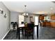 Inviting dining area features a modern chandelier, and stylish decor, seamlessly connected to the kitchen at 8325 Chesterhill Ln, Indianapolis, IN 46239