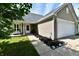 Charming single-Gathering home featuring a two-car garage, neutral siding, and a welcoming front walkway with landscape at 8325 Chesterhill Ln, Indianapolis, IN 46239
