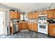 Well-lit kitchen featuring gray walls, marbled floor, and light wood cabinets and stainless steel appliances at 8325 Chesterhill Ln, Indianapolis, IN 46239