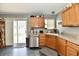 Spacious kitchen and dining area features stainless steel appliances, light wood cabinets, and sliding glass door at 8325 Chesterhill Ln, Indianapolis, IN 46239