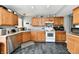 Well-lit kitchen featuring gray walls, marbled floor, and light wood cabinets and stainless steel appliances at 8325 Chesterhill Ln, Indianapolis, IN 46239