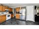 Updated kitchen features light wood cabinets, stainless steel refrigerator and appliances, and gray marbled floor at 8325 Chesterhill Ln, Indianapolis, IN 46239