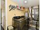 Laundry room with front load washer and dryer, open shelving and laundry supplies at 8325 Chesterhill Ln, Indianapolis, IN 46239