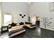 Open-concept living room with neutral walls, stylish couch, and access to the dining area at 8325 Chesterhill Ln, Indianapolis, IN 46239