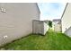 Side yard with a storage shed and well-maintained lawn, offering practicality and green space at 8325 Chesterhill Ln, Indianapolis, IN 46239