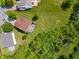 An aerial view showing the backyard and the house situated on the large lot, with nearby houses, streets, and green foliage at 8631 Belle Union Pl, Indianapolis, IN 46113