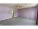 Large bedroom with purple walls, ceiling fan, and adjacent bathroom at 8631 Belle Union Pl, Indianapolis, IN 46113