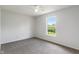 Bedroom featuring white walls, carpet flooring, and a window with lush greenery at 8631 Belle Union Pl, Indianapolis, IN 46113