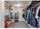 Walk-in closet with custom shelving, hanging racks, and carpet flooring at 8631 Belle Union Pl, Indianapolis, IN 46113