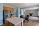 View of the kitchen and dining area with wood floors, a table, and an adjacent living room at 8631 Belle Union Pl, Indianapolis, IN 46113