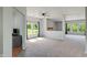 Spacious living room with a fireplace, large windows, and plush carpeting at 8631 Belle Union Pl, Indianapolis, IN 46113