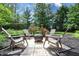 Backyard with a stone patio, four Adirondack chairs and a fire pit, perfect for outdoor entertaining at 876 Box Turtle Ct, Columbus, IN 47201