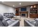 Finished basement with gray leather furniture, fireplace and built in shelves at 876 Box Turtle Ct, Columbus, IN 47201