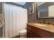 Bathroom with white shower curtain, granite countertop, and dark wood cabinetry at 876 Box Turtle Ct, Columbus, IN 47201