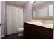 This bathroom features a vanity with a dark wood cabinet, neutral countertop and a large mirror at 876 Box Turtle Ct, Columbus, IN 47201