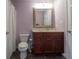 This bathroom features a vanity with a dark wood cabinet, neutral countertop, toilet and shower with curtain at 876 Box Turtle Ct, Columbus, IN 47201
