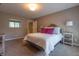 This bedroom features neutral carpet, a window and a bed with plush pillows and throw blanket at 876 Box Turtle Ct, Columbus, IN 47201