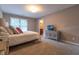 This bedroom features neutral carpet, a window and a bed with plush pillows and throw blanket at 876 Box Turtle Ct, Columbus, IN 47201