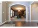 Elegant dining room visible through an arched doorway, featuring a chandelier and ample natural light at 876 Box Turtle Ct, Columbus, IN 47201