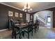 Well-appointed dining room with a chandelier, stylish furnishings, and a view of the foyer, ideal for entertaining at 876 Box Turtle Ct, Columbus, IN 47201