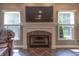 Close up of fireplace with white mantel, tile hearth, and mounted television at 876 Box Turtle Ct, Columbus, IN 47201