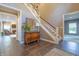 Spacious foyer with tile flooring, staircase, and decorative furniture, creating a welcoming ambiance at 876 Box Turtle Ct, Columbus, IN 47201