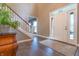 Elegant foyer features a staircase, tiled floors, and a front door with glass panels, enhancing natural light at 876 Box Turtle Ct, Columbus, IN 47201
