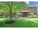 Charming brick home featuring a well-manicured lawn and a mature tree in the front yard at 876 Box Turtle Ct, Columbus, IN 47201