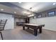 Billiards table in finished basement recreation room with comfortable seating and modern lighting at 876 Box Turtle Ct, Columbus, IN 47201
