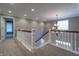 Spacious hallway with a staircase and chandelier, showcasing the upper level's design and flow of the home at 876 Box Turtle Ct, Columbus, IN 47201