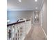 Hallway featuring carpet, white trim, and a view of the upper level, showcasing the home's spacious design at 876 Box Turtle Ct, Columbus, IN 47201