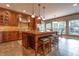 A gourmet kitchen is equipped with stainless steel appliances, granite countertops, tiled floor, and a center island with chairs at 876 Box Turtle Ct, Columbus, IN 47201
