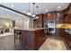This kitchen features custom cabinets, stainless steel appliances, granite countertops, and a center island at 876 Box Turtle Ct, Columbus, IN 47201
