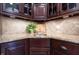 This kitchen has a corner sink with stylish countertops, custom cabinets, and stainless steel appliances at 876 Box Turtle Ct, Columbus, IN 47201