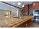 A granite countertop is featured in this kitchen with stainless steel appliances and custom cabinets at 876 Box Turtle Ct, Columbus, IN 47201