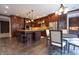 Spacious kitchen with large island, dark wood cabinets, granite countertops, and stainless appliances at 876 Box Turtle Ct, Columbus, IN 47201