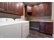 Well-equipped laundry room with modern appliances, ample cabinet space, and a practical sink area at 876 Box Turtle Ct, Columbus, IN 47201
