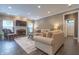 Cozy living room with fireplace, tile flooring, neutral couches and large windows at 876 Box Turtle Ct, Columbus, IN 47201
