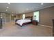 This spacious main bedroom includes neutral walls, carpet and multiple windows for ample light at 876 Box Turtle Ct, Columbus, IN 47201