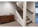 Stairwell with carpeted stairs, wooden railing and chest of drawers on landing at 876 Box Turtle Ct, Columbus, IN 47201