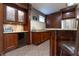 Close up of the granite counters and cherry cabinets at the finished basement wet bar at 876 Box Turtle Ct, Columbus, IN 47201