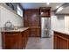 Finished basement wet bar featuring ample cabinet space, granite counters, and stainless refrigerator at 876 Box Turtle Ct, Columbus, IN 47201