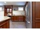 Finished basement wet bar with stainless appliances, granite counters, and stained cabinets at 876 Box Turtle Ct, Columbus, IN 47201